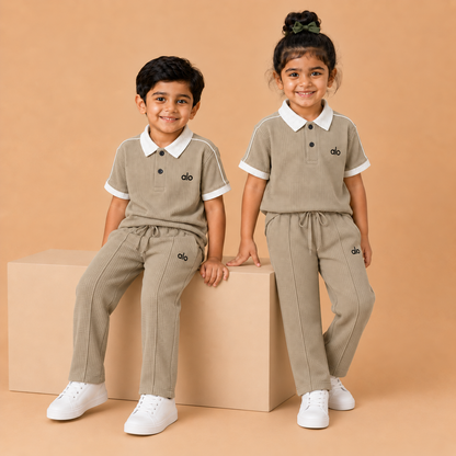 alo Polo Cord set — Beige x White kids seated lifestyle, straight pleated trousers