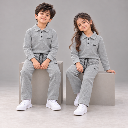 Boy and girl seated in the Stone Grey Geometric Textured Polo Winter Co-ord Set