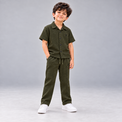Born 78 LV Army Green button-down co-ord set in corrected dark olive shade, boy full-length view