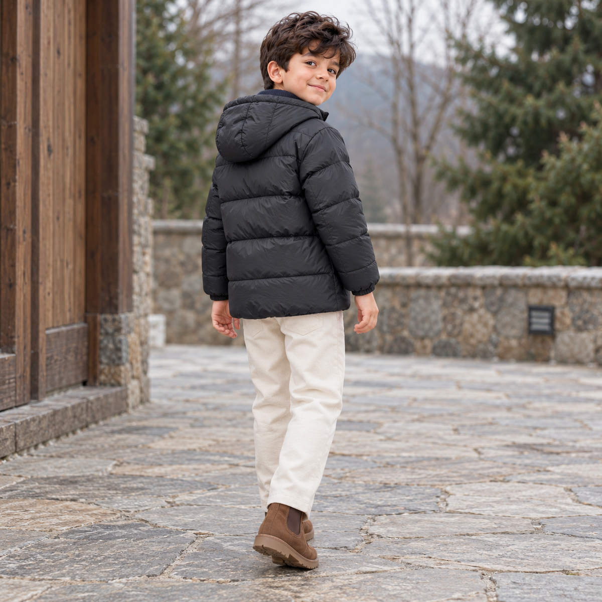 Back view of the black Northwood hooded puffer jacket worn by a boy