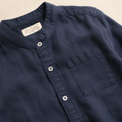 Navy cotton band-collar shirt fabric and pocket close-up