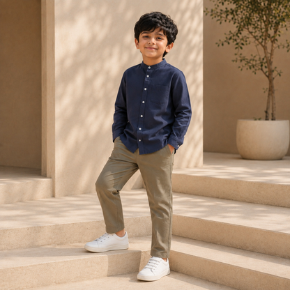 Older boy wearing navy cotton band-collar shirt