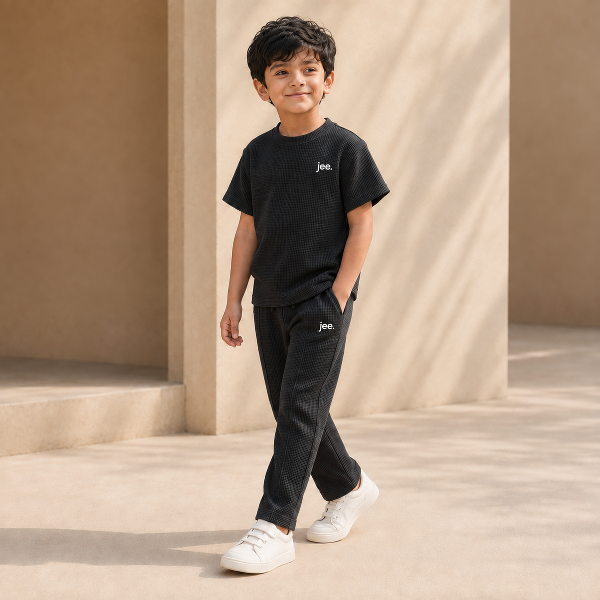 Boy wearing Black Round Neck cord set with jee. logo