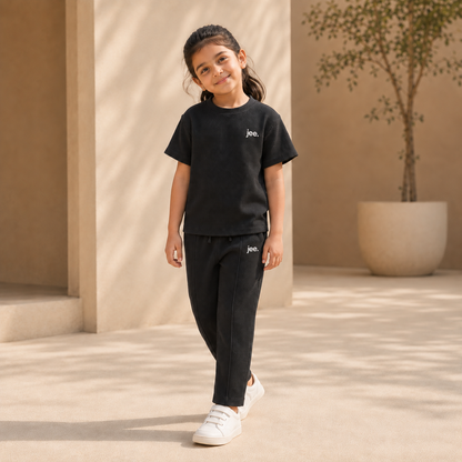 Girl wearing Black Round Neck cord set with jee. logo
