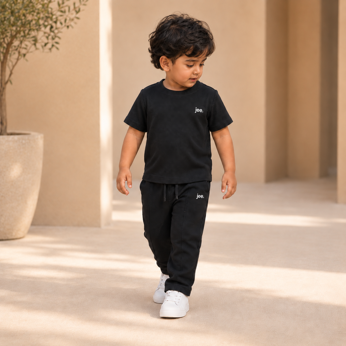 Toddler boy wearing Black Round Neck cord set with jee. logo