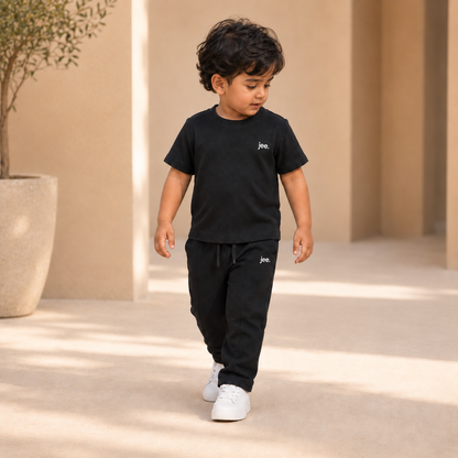 Toddler boy wearing Black Round Neck cord set with jee. logo