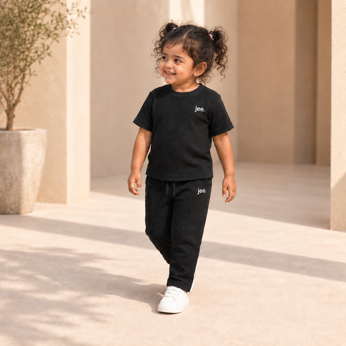 Toddler girl wearing Black Round Neck cord set with jee. logo