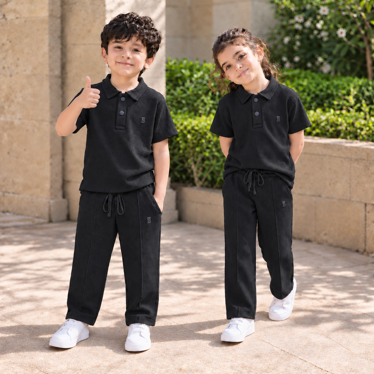 BORN 78 Waffle-Knit Polo Cord Set in black — natural boy and girl lifestyle image